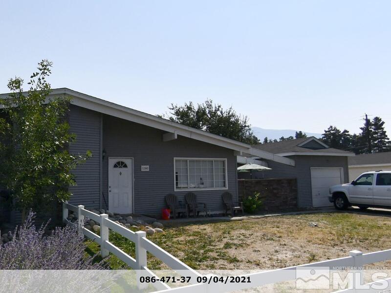 a view of house with backyard and trees