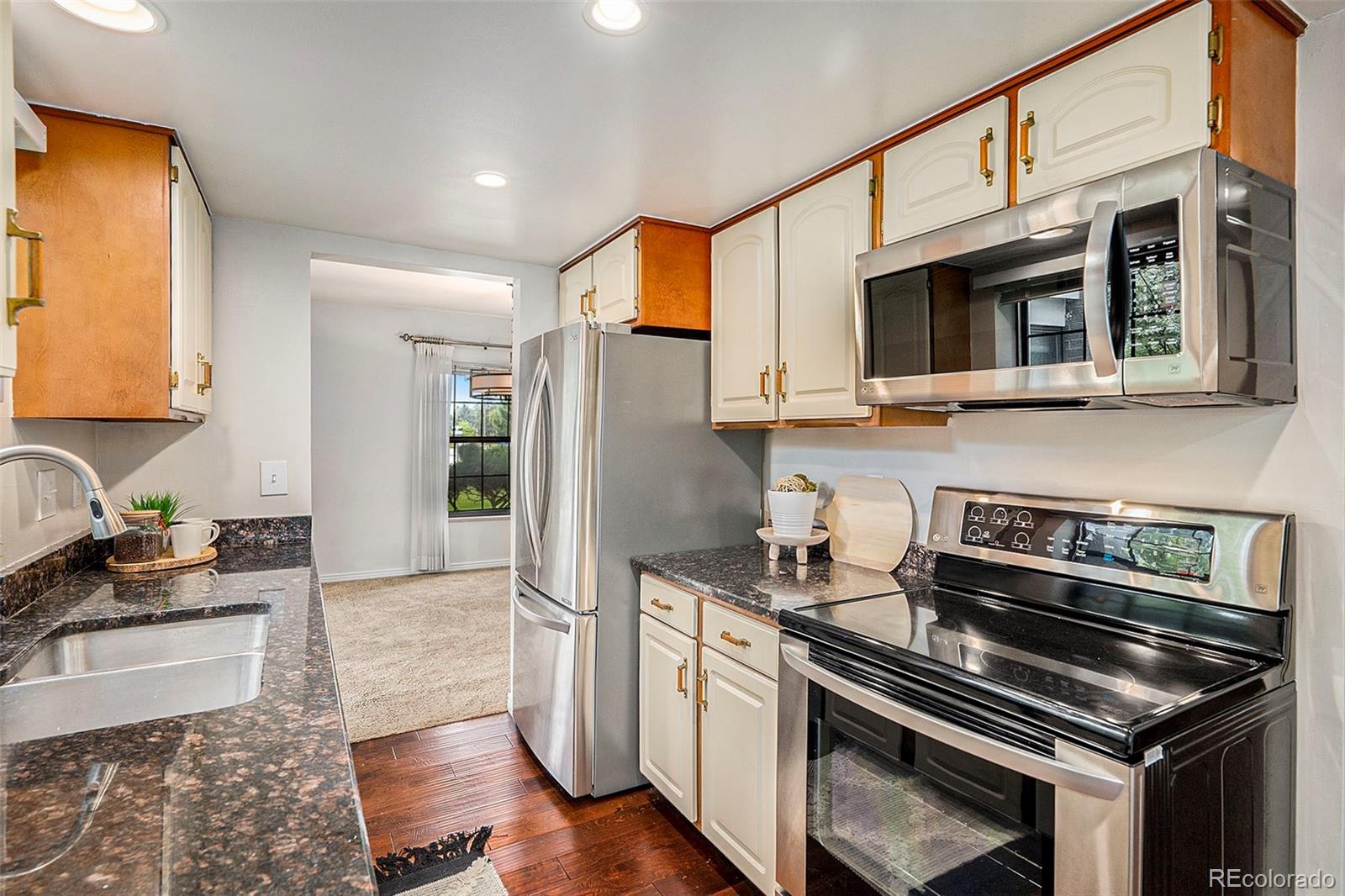 a kitchen with stainless steel appliances granite countertop a stove and a sink