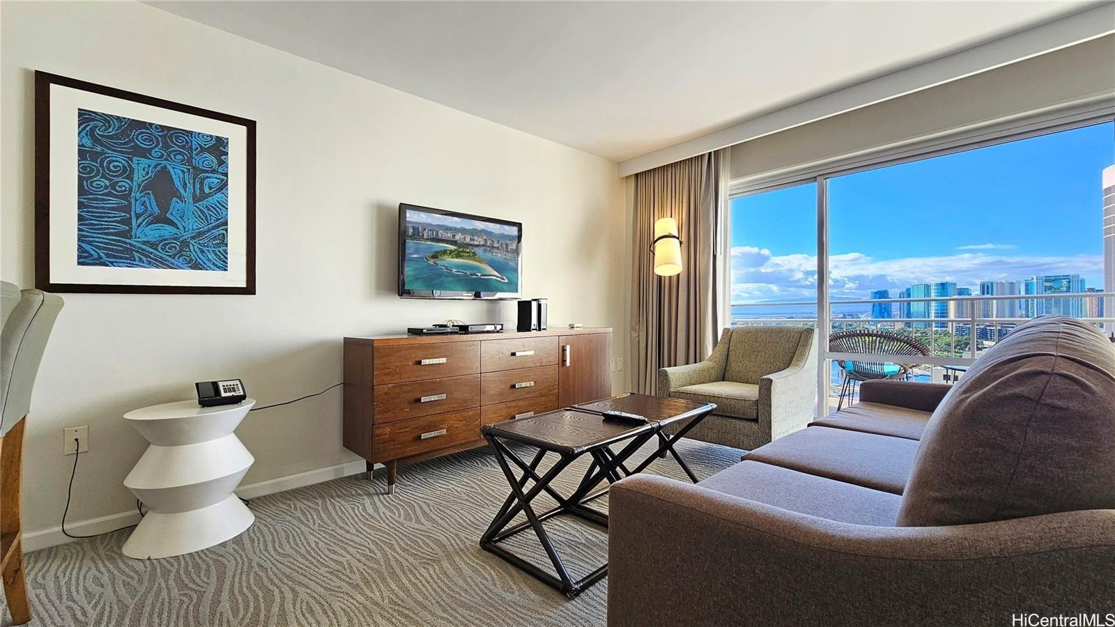 a living room with furniture and a floor to ceiling window