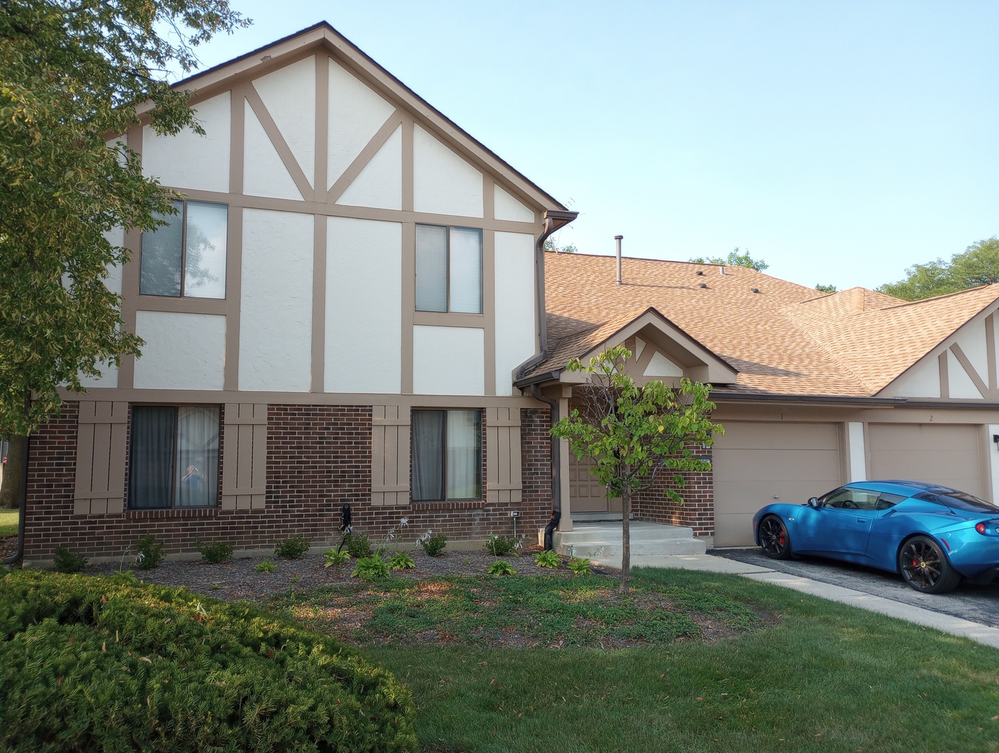 a front view of a house with a yard and garage