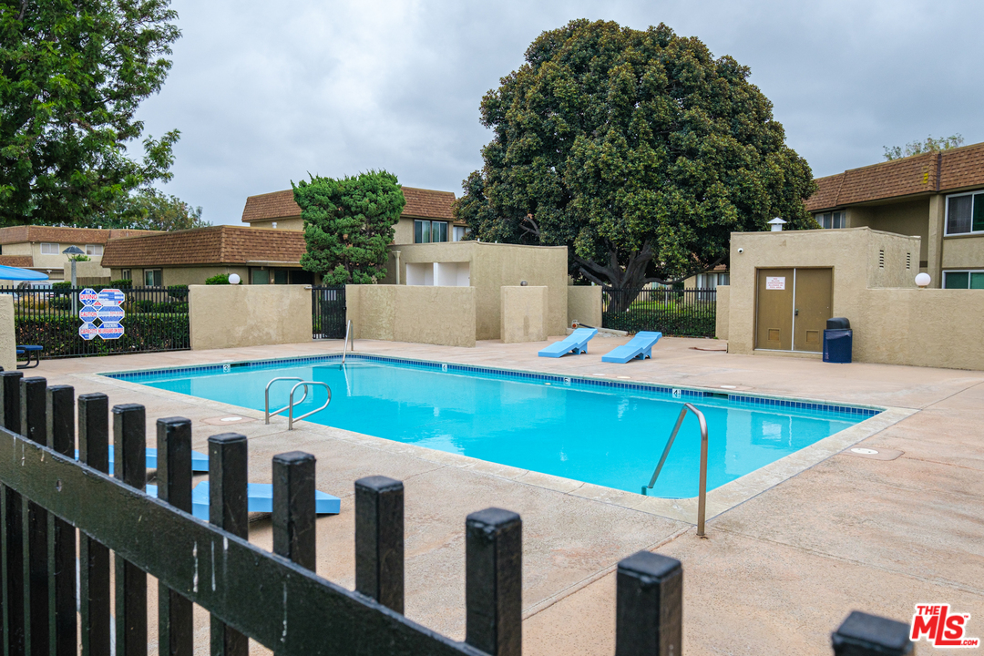 a view of a house with pool and chairs