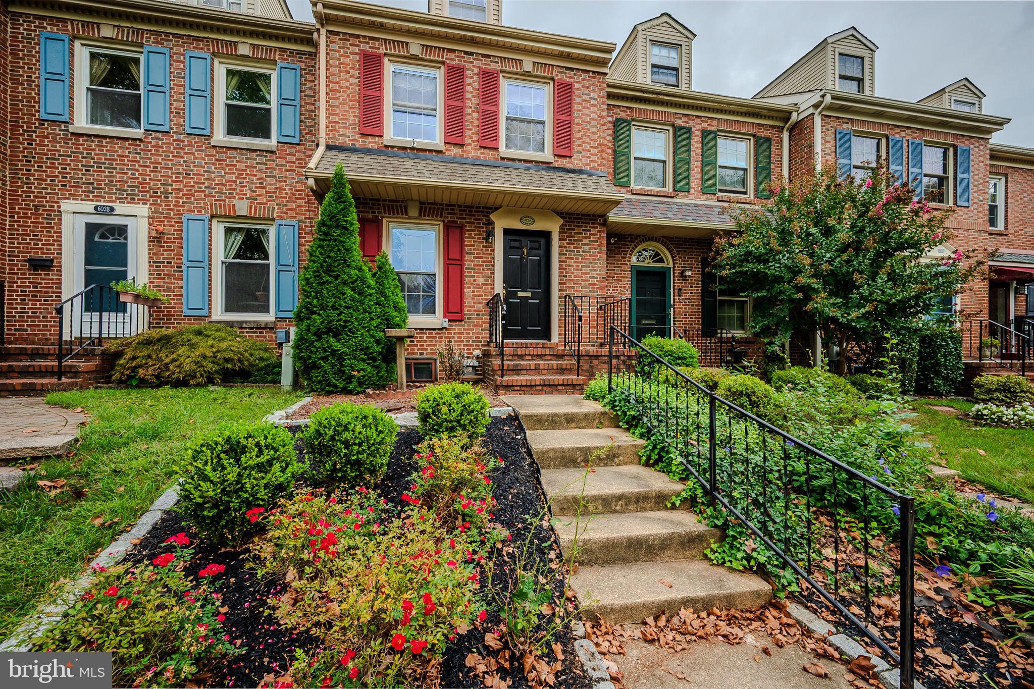 front view of a brick house with a yard