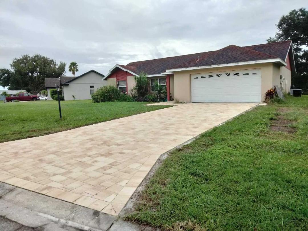 a view of house with backyard and garden