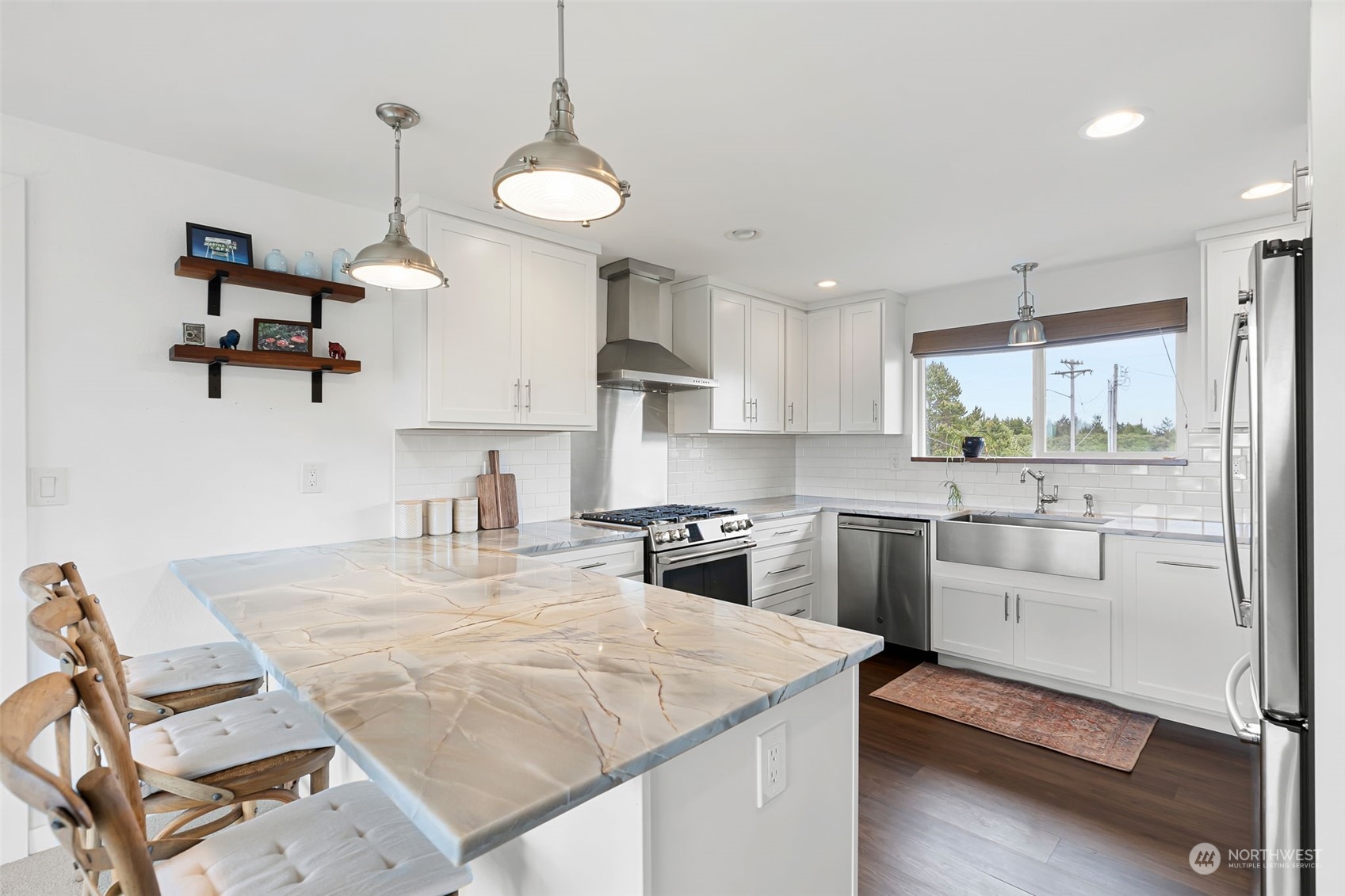 a kitchen with kitchen island a stove a sink and a refrigerator