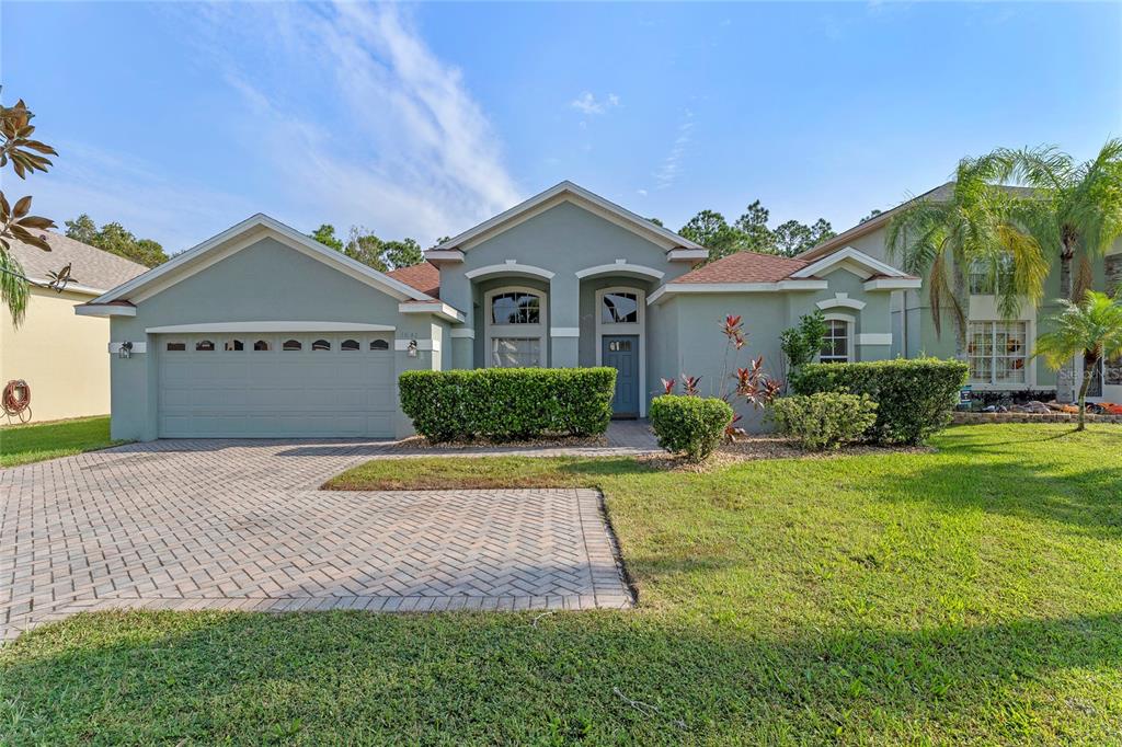 a front view of a house with a yard and garage