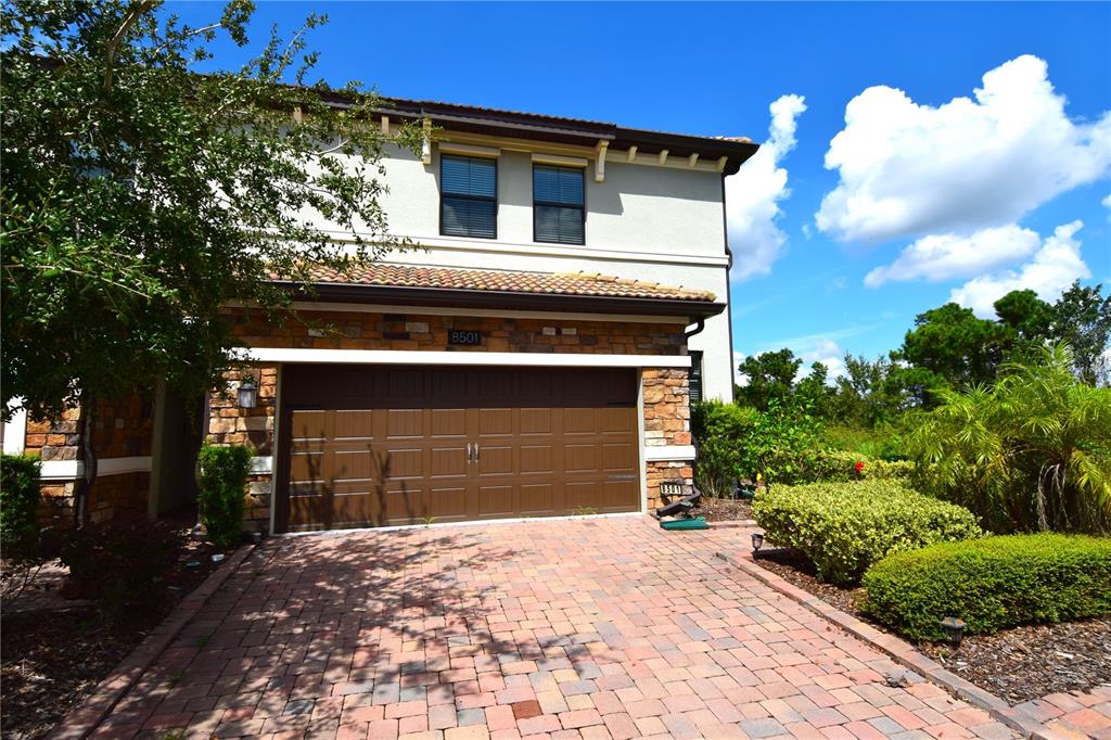 a front view of a house with a yard and garage