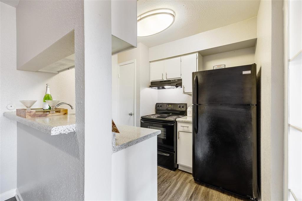 a kitchen with stainless steel appliances granite countertop a refrigerator and a stove