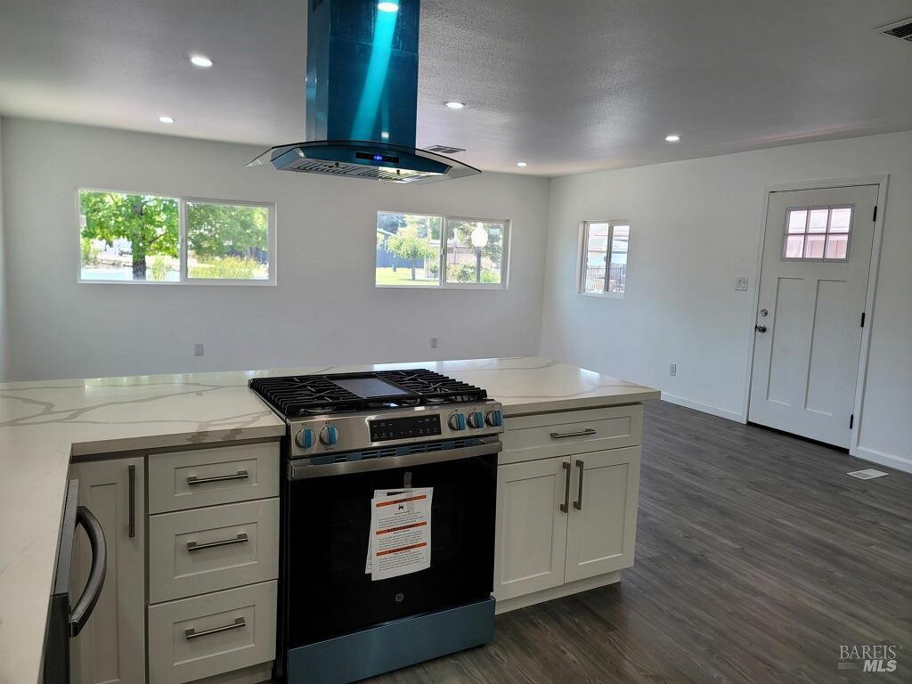 a kitchen with stainless steel appliances granite countertop a stove and a sink