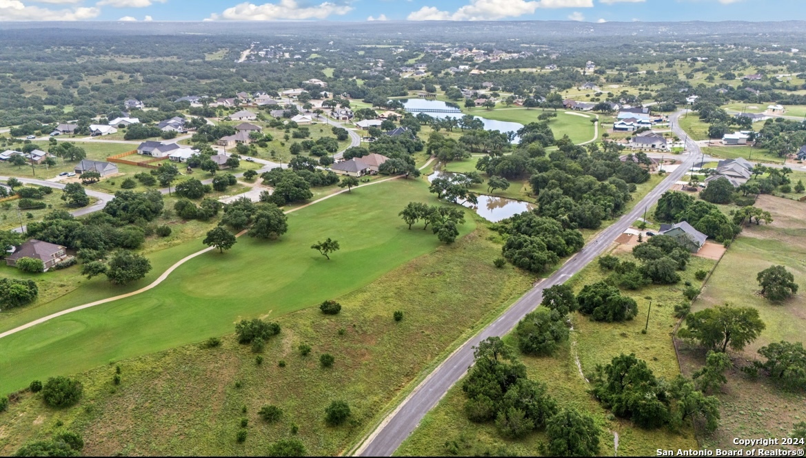 an aerial view of a houses with a yard