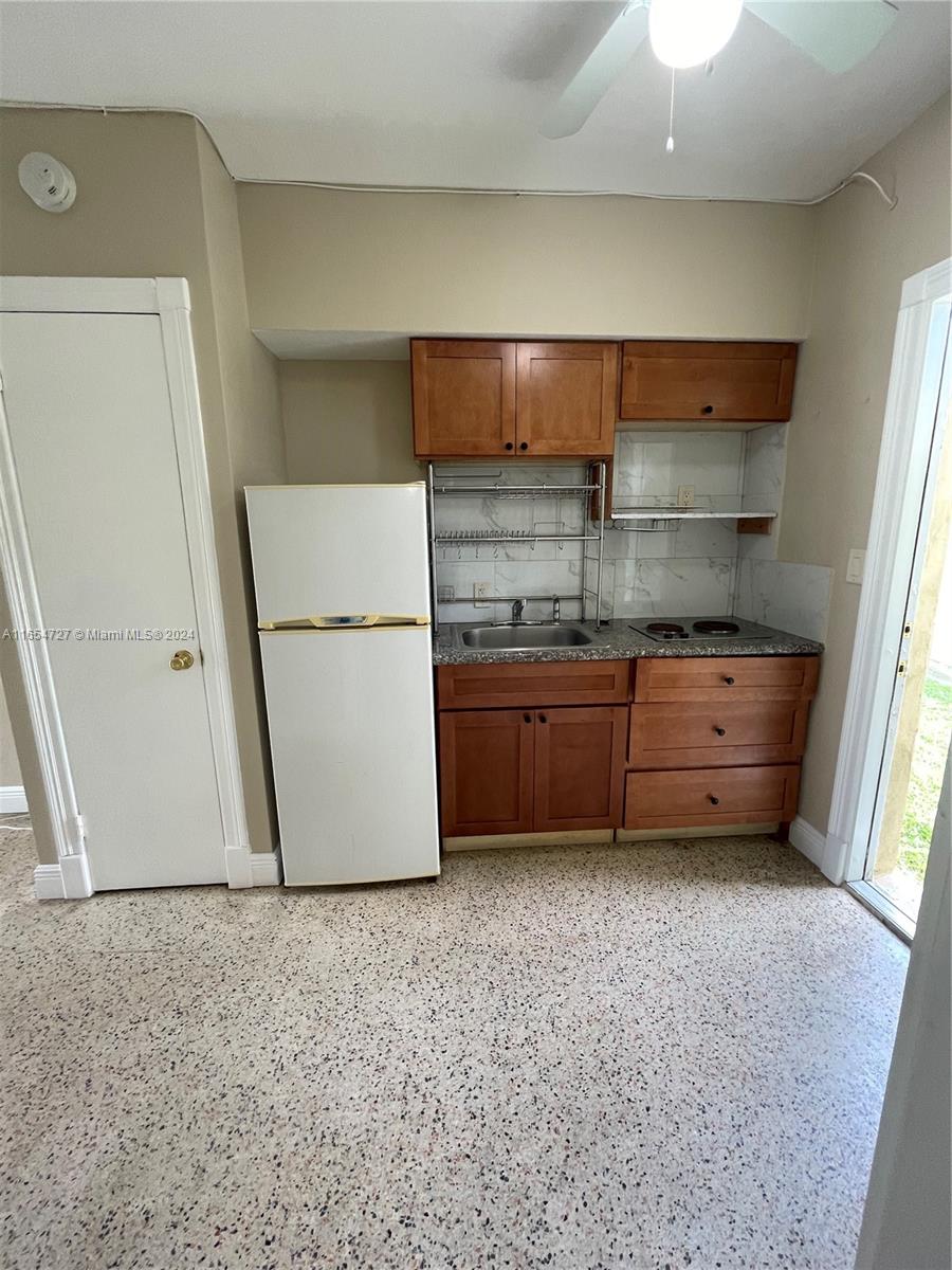 a kitchen with a refrigerator and cabinets