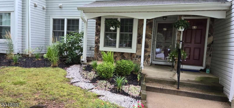 a house with potted plants in front of door