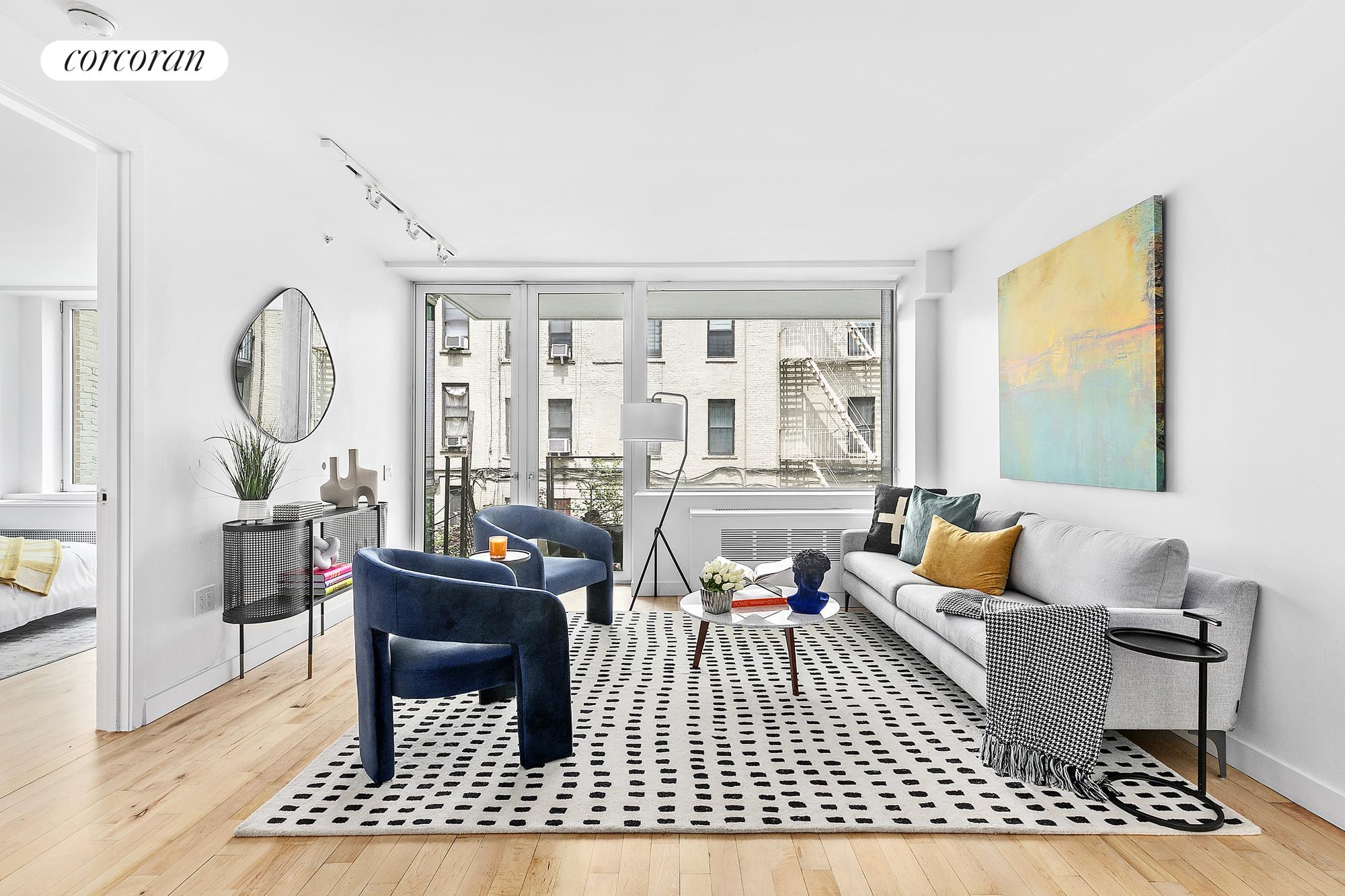 a living room with furniture a rug and a window