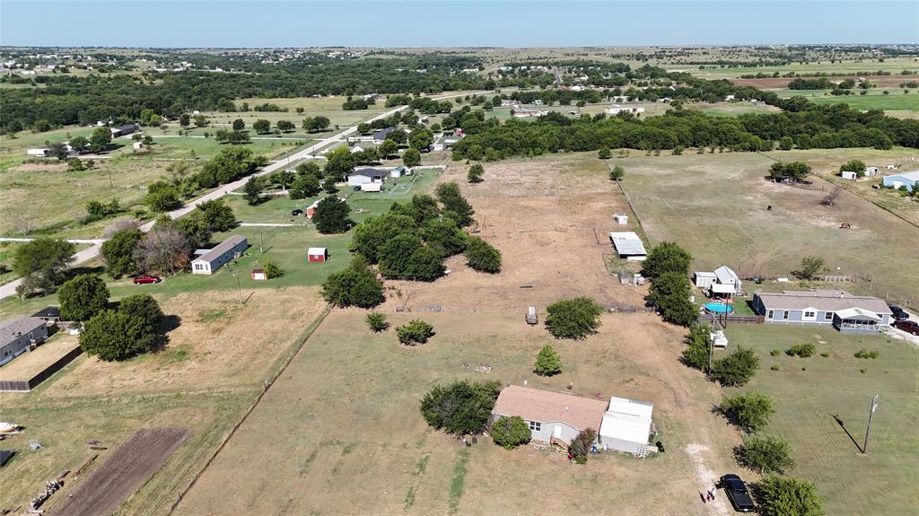 an aerial view of a houses with a yard