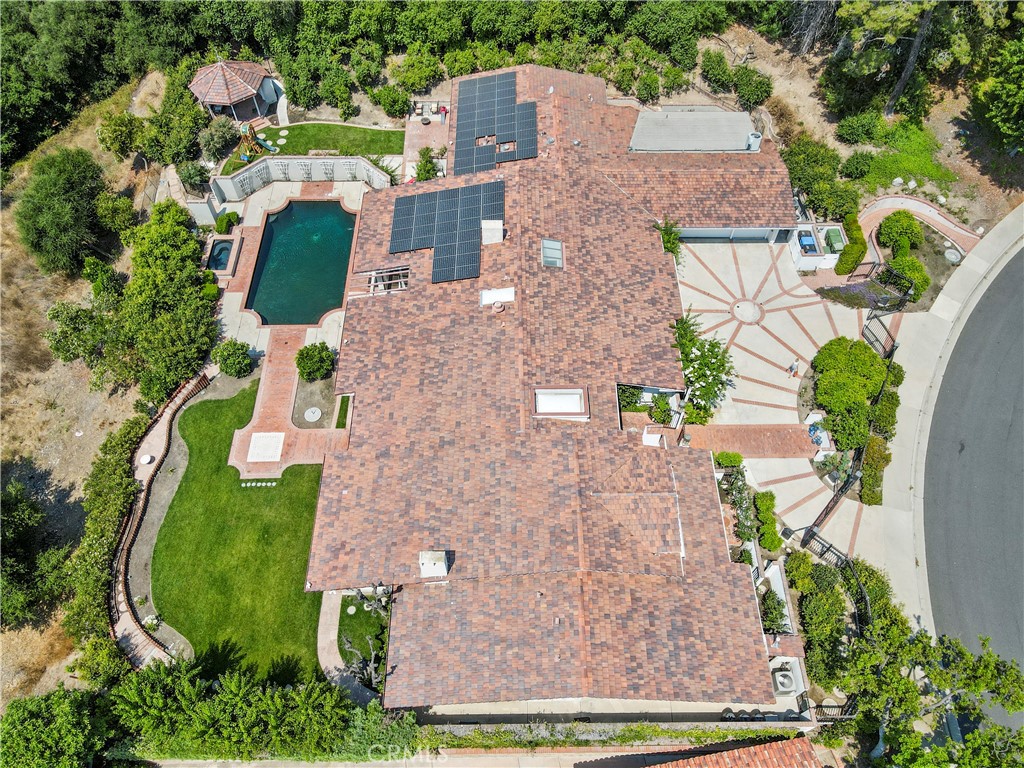 an aerial view of a house with outdoor space swimming pool