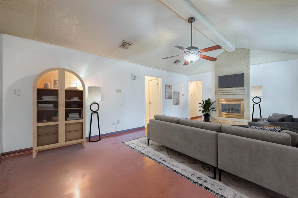 a living room with furniture a ceiling fan and a rug