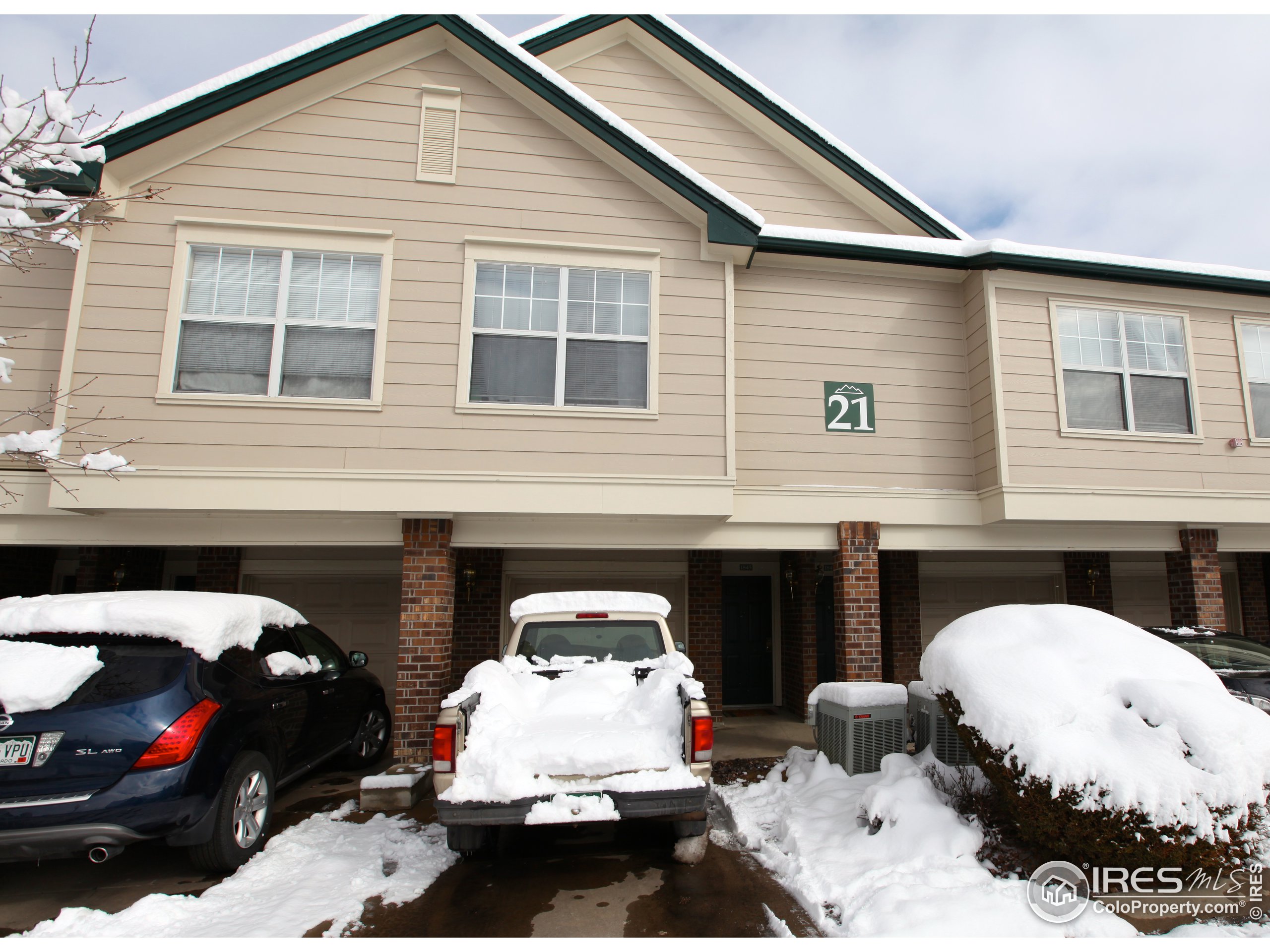 a couple of cars parked in front of the house