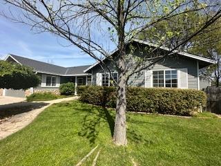 a front view of house with yard and green space