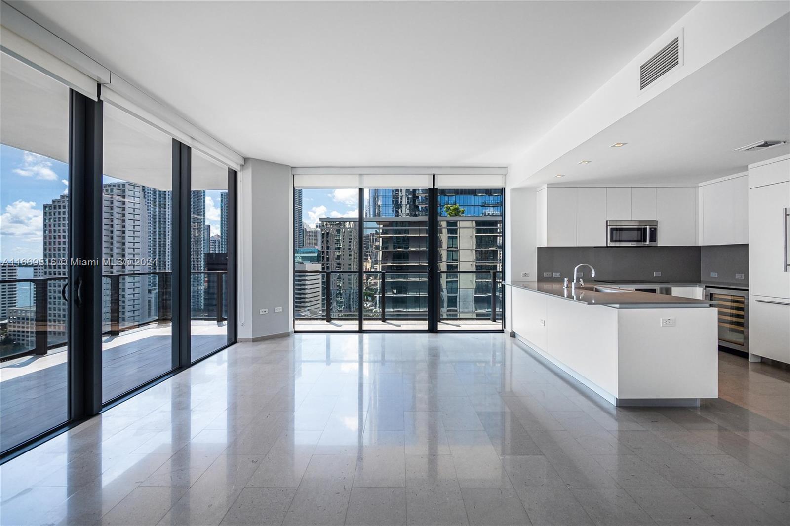 a open kitchen with granite countertop a stove top oven a sink and a granite counter top