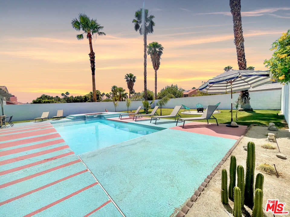 a swimming pool with yard and outdoor seating