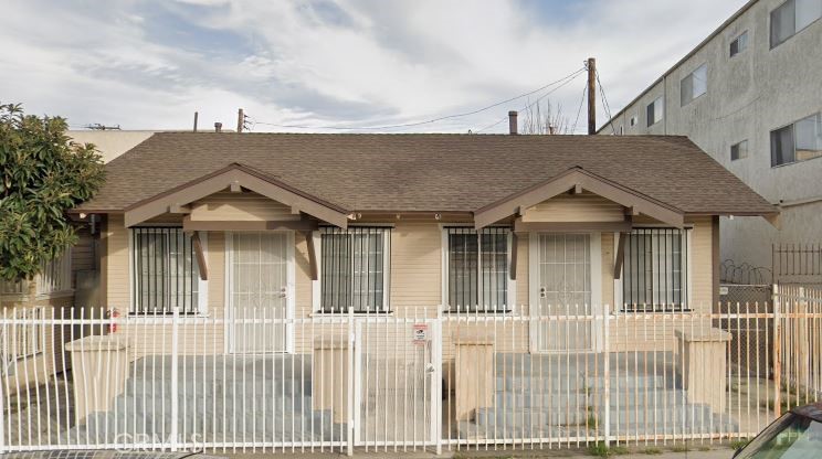 a front view of a house with a fence