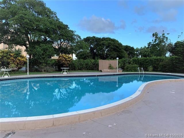 a view of a swimming pool with a yard