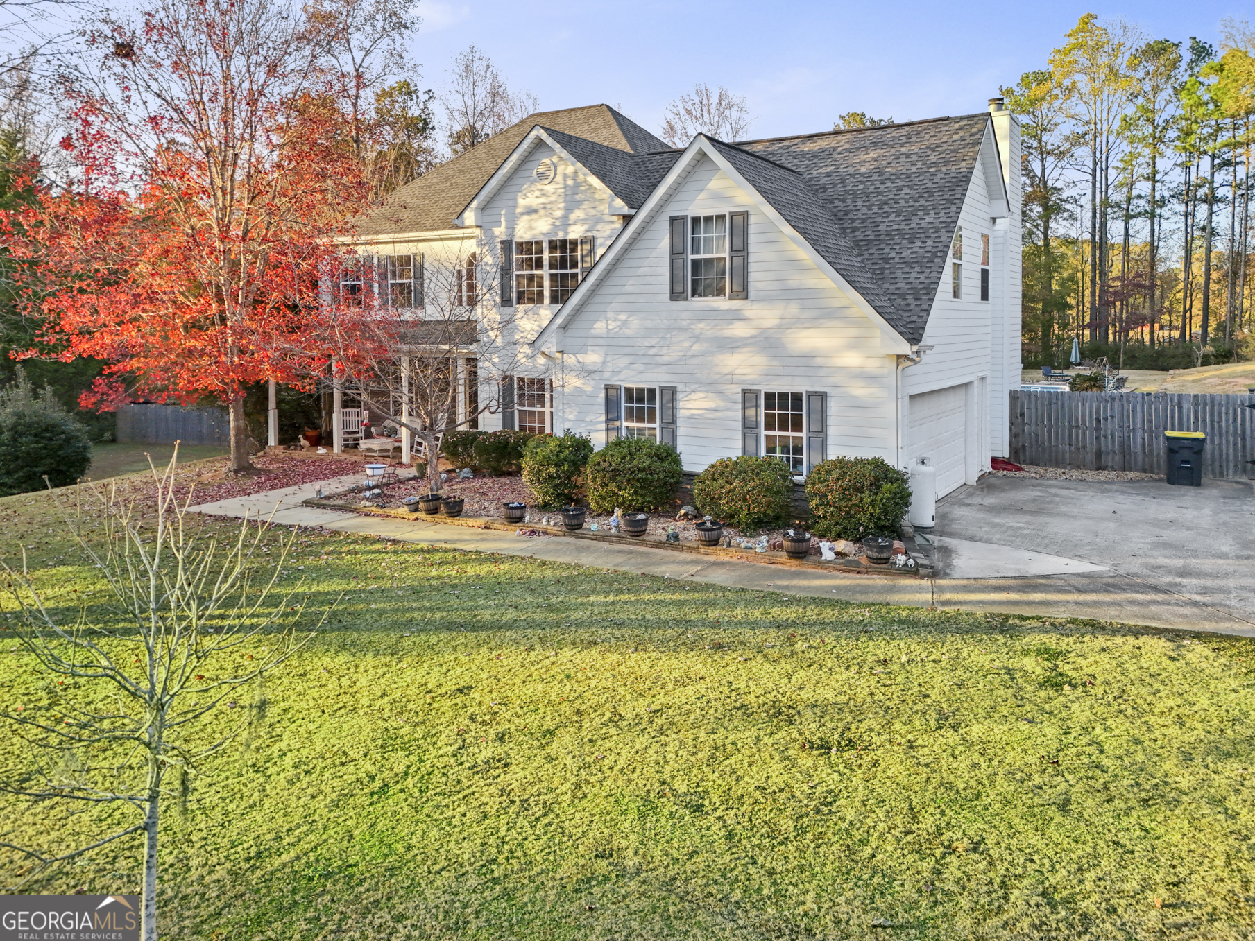 a front view of a house with swimming pool having outdoor seating