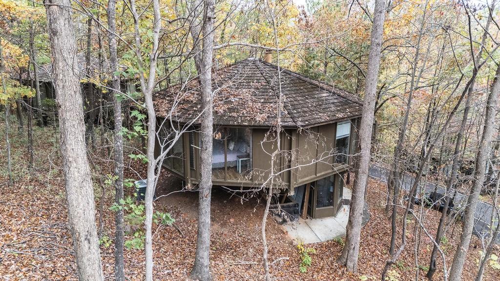 a aerial view of a house with balcony and trees