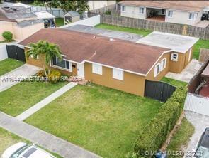 an aerial view of a house with a garden