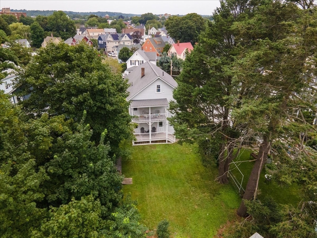 a aerial view of a house with a yard