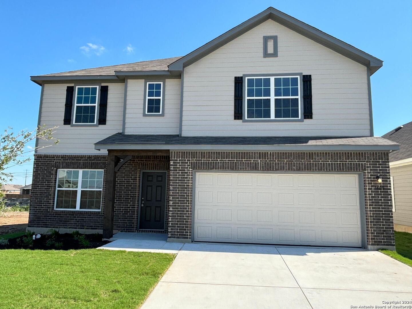 a front view of a house with a yard