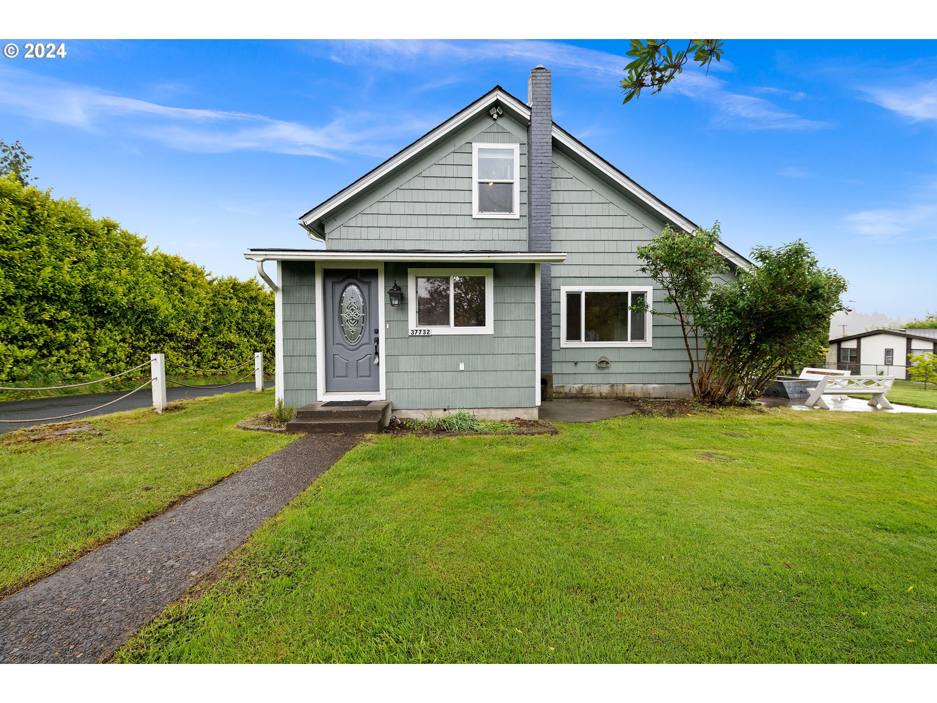 a front view of house with yard and green space