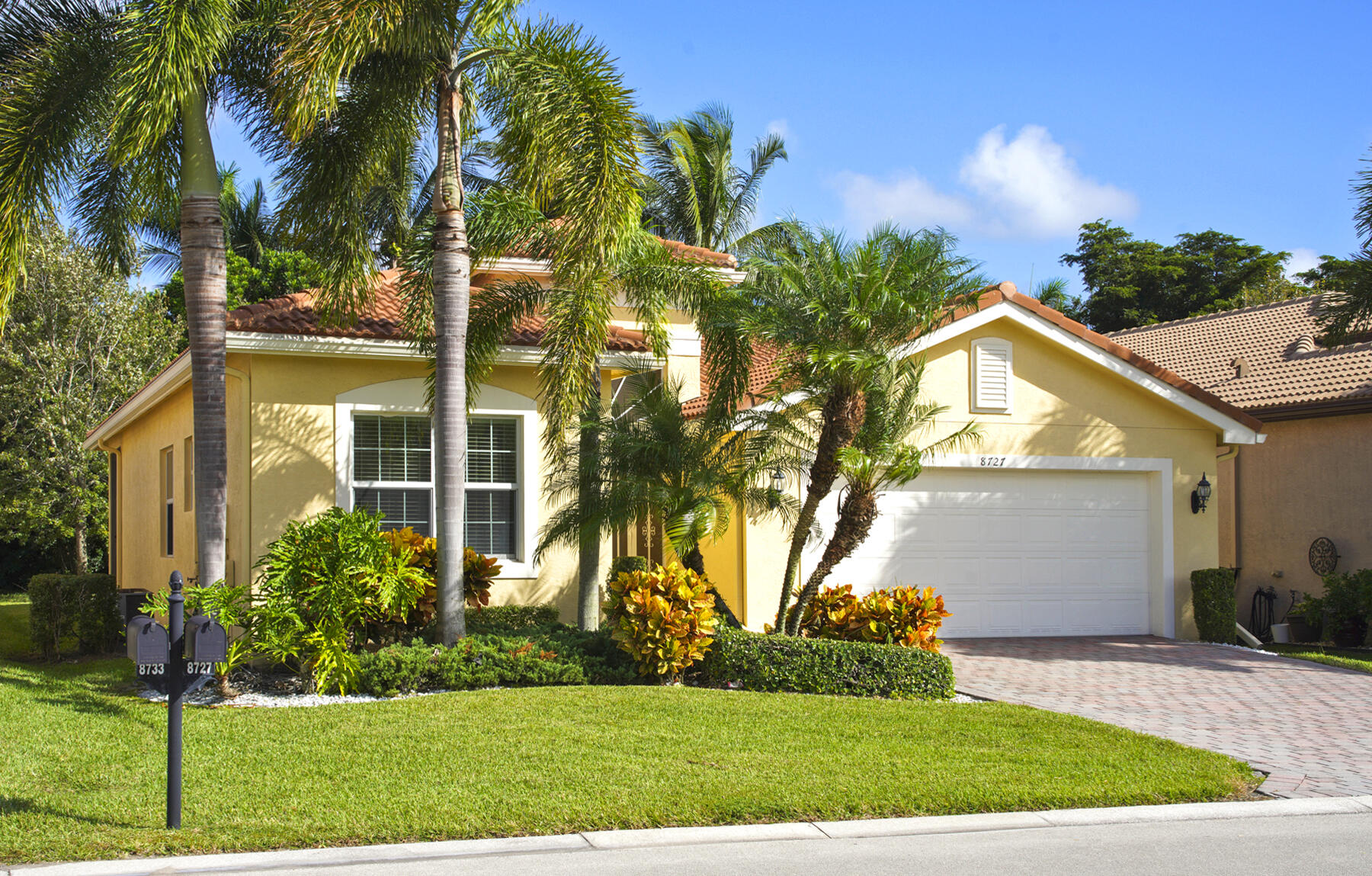 a view of a house with a yard and plants