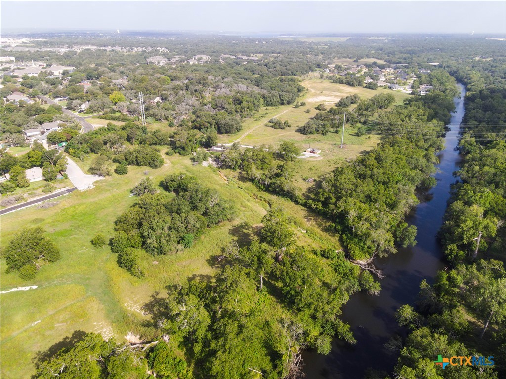 a view of a city with green field