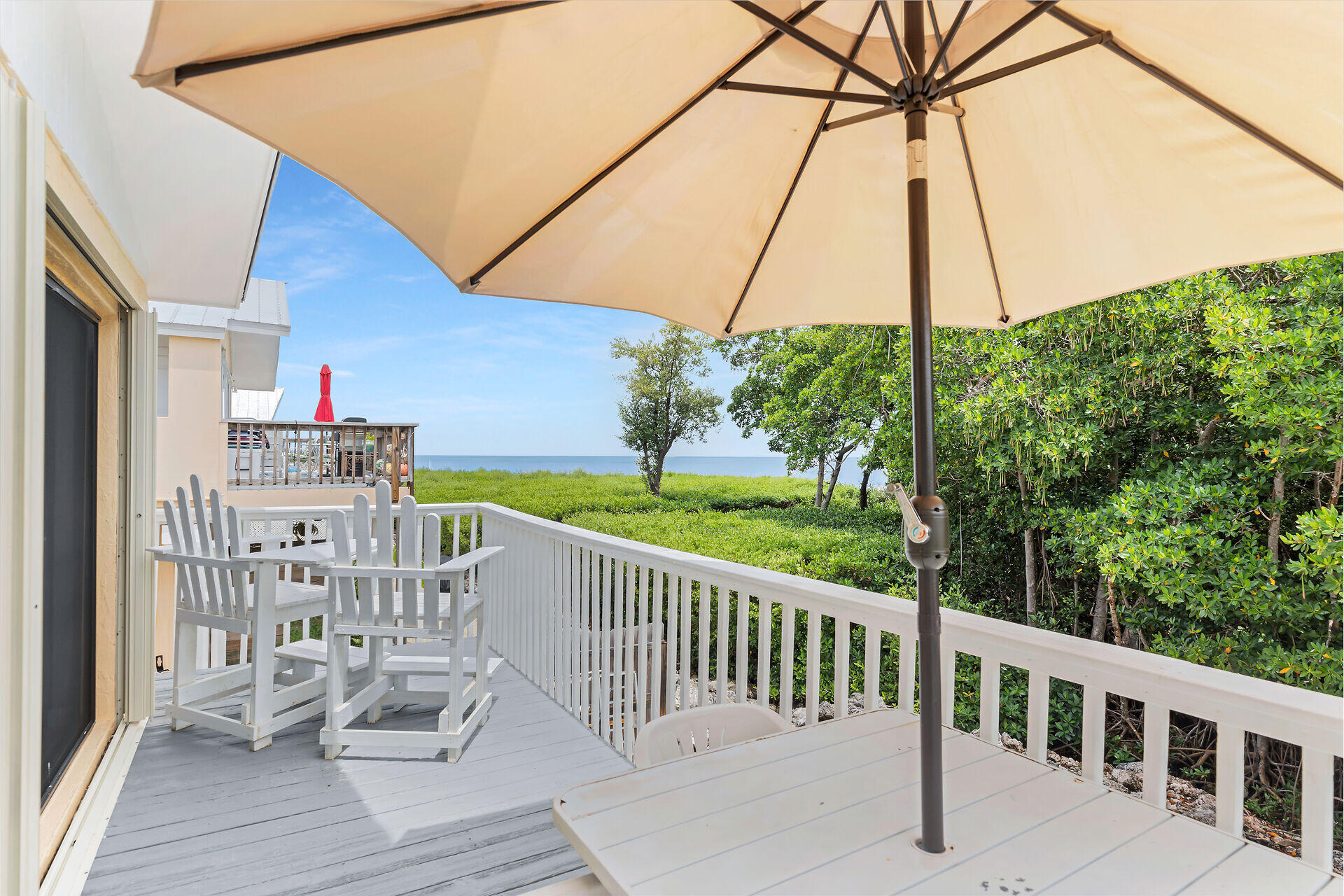 a view of a deck with a chair and wooden floor