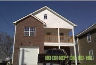 a front view of a house with garage