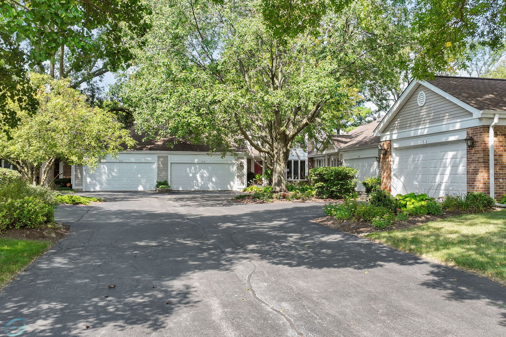 a front view of a house with a yard and a garage