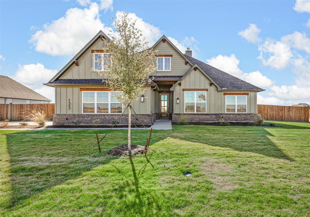 a view of a house with a backyard and a patio