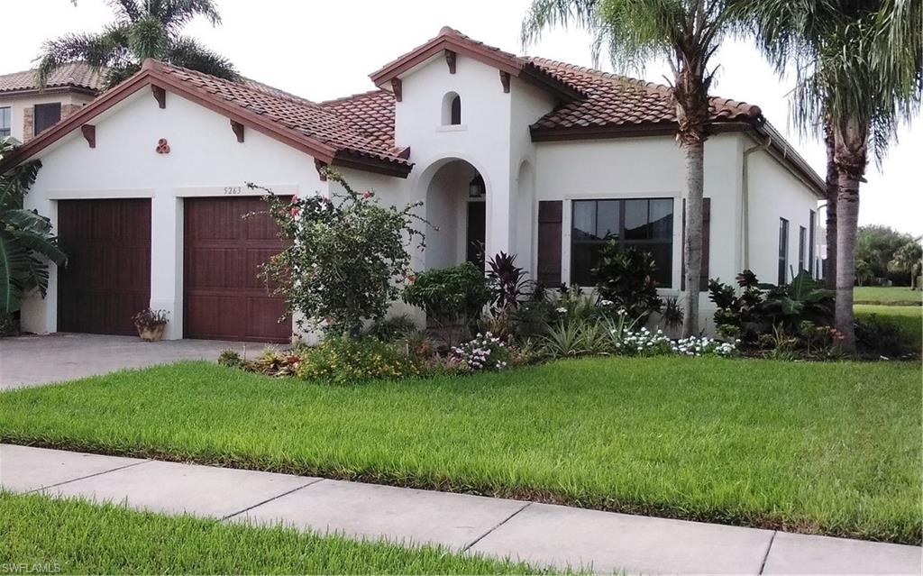 a front view of a house with a garden and plants