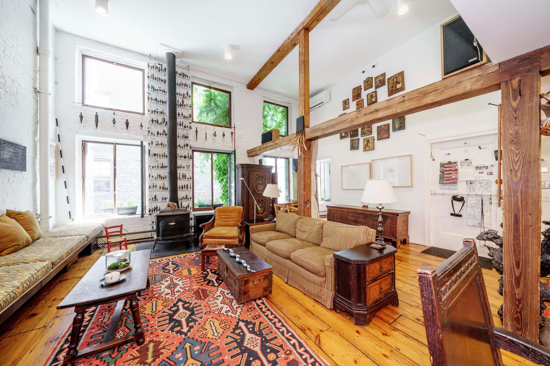 a living room with furniture fireplace and a large window