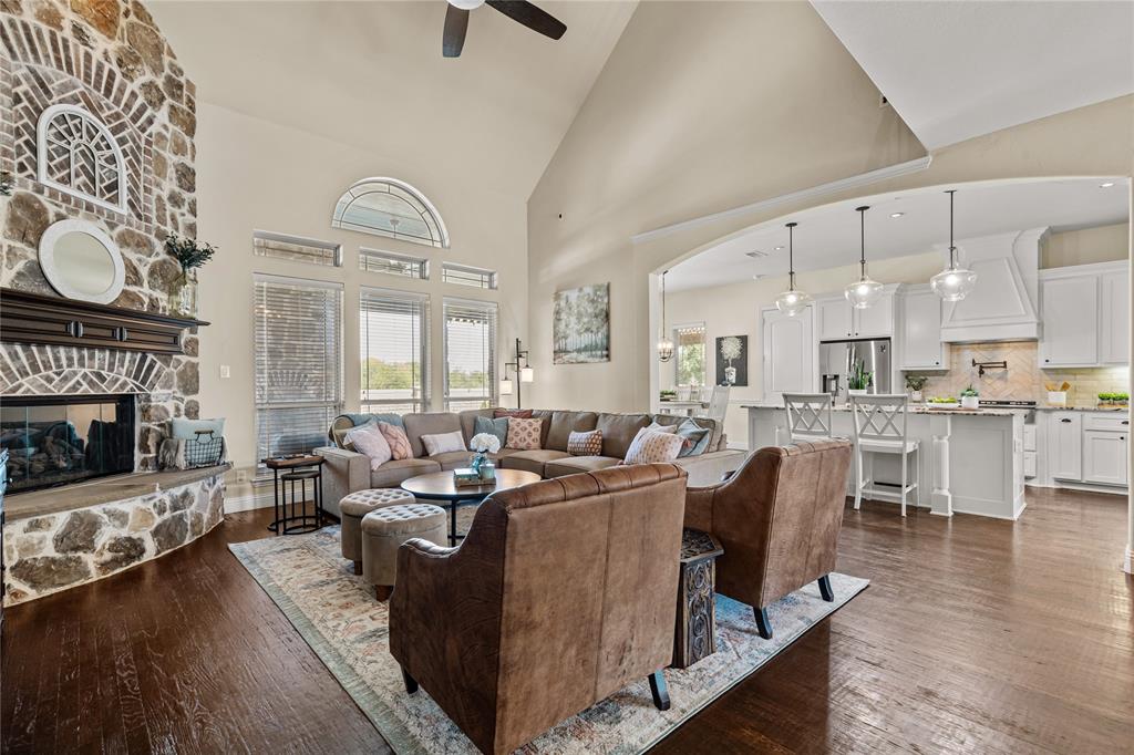 a living room with fireplace furniture and a wooden floor