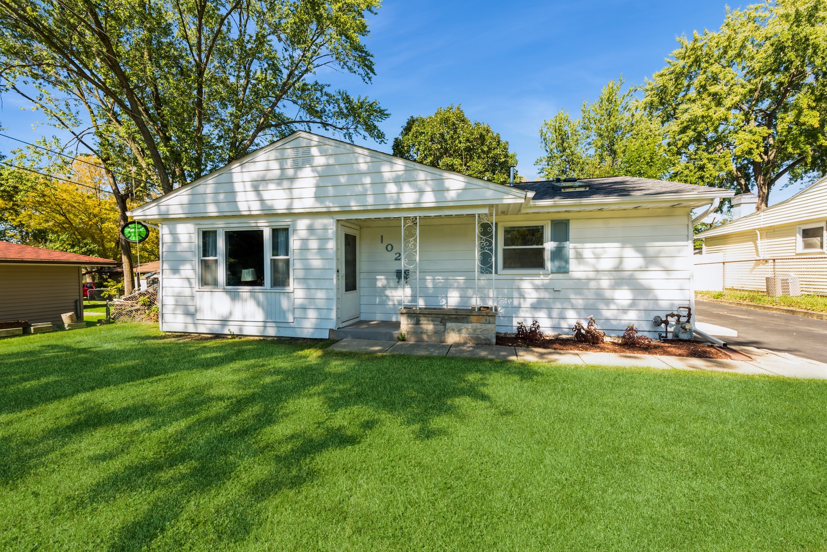 a front view of house with yard and green space