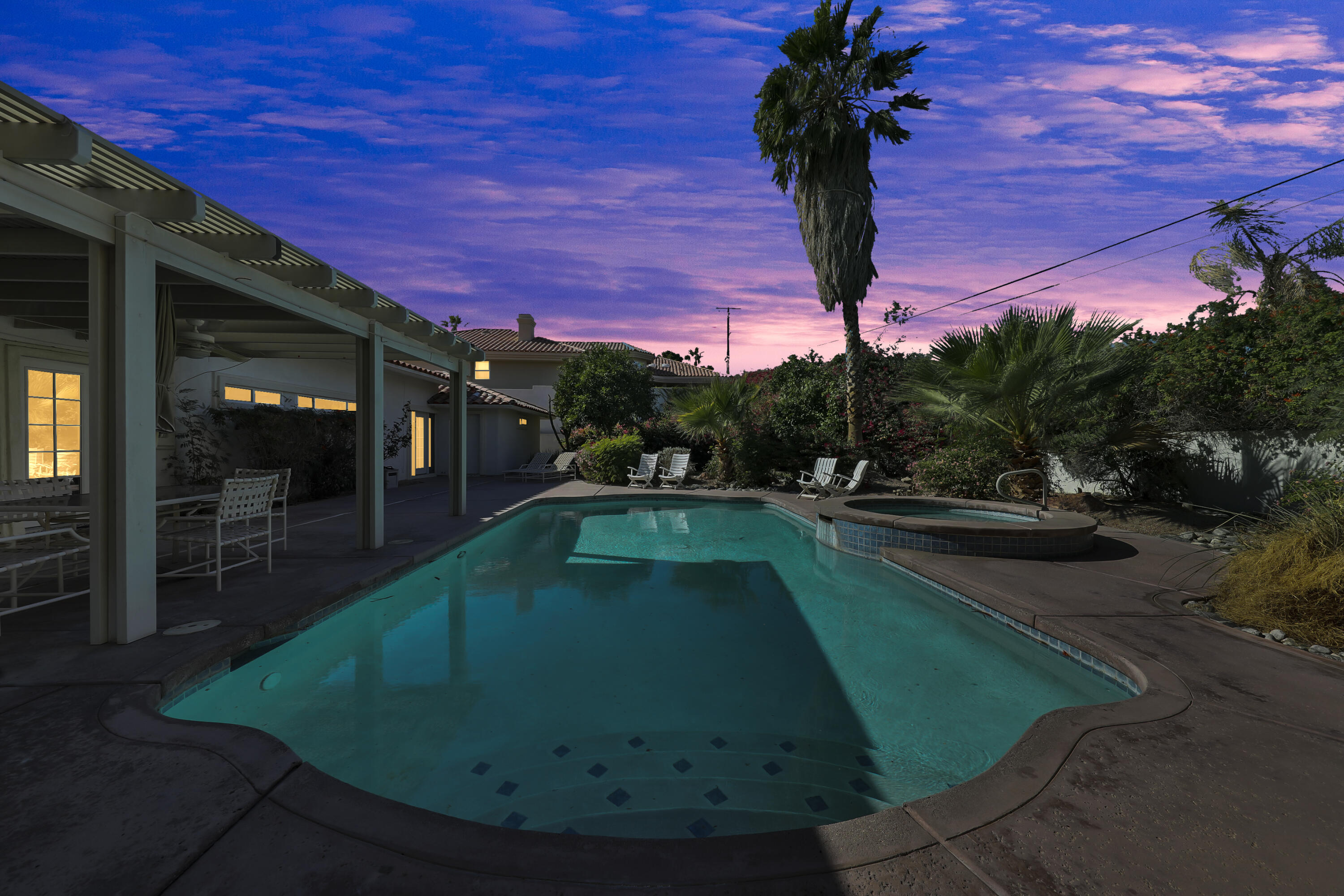 a view of a swimming pool with a yard