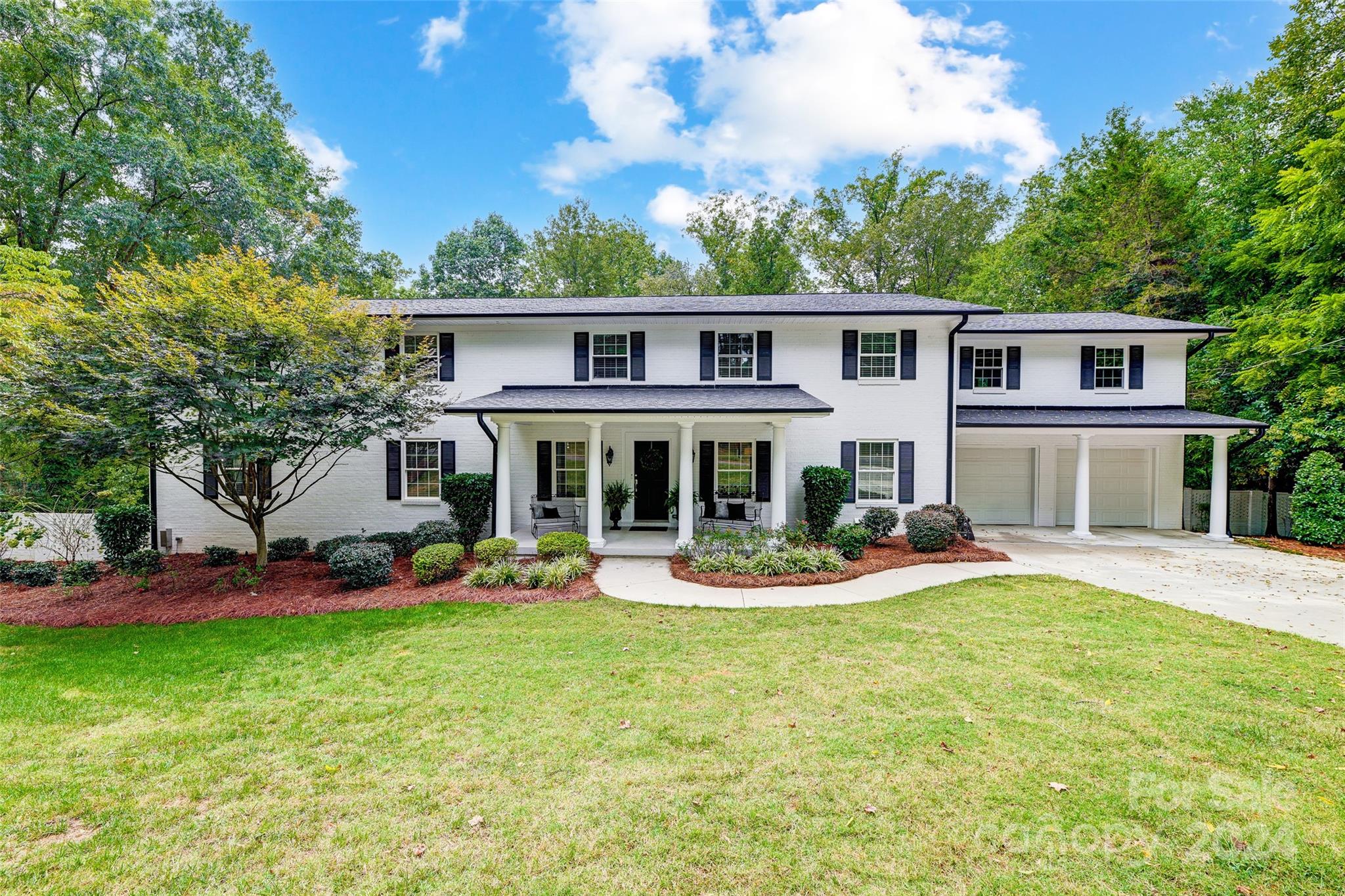 a front view of house with yard outdoor seating and garden