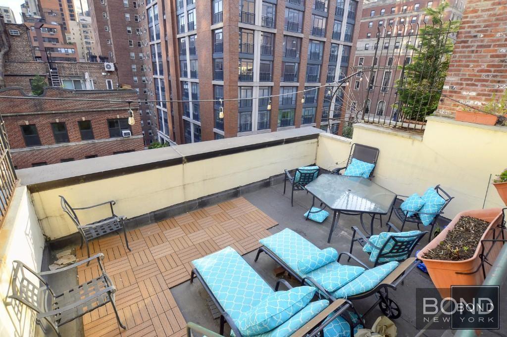 a balcony with table and chairs