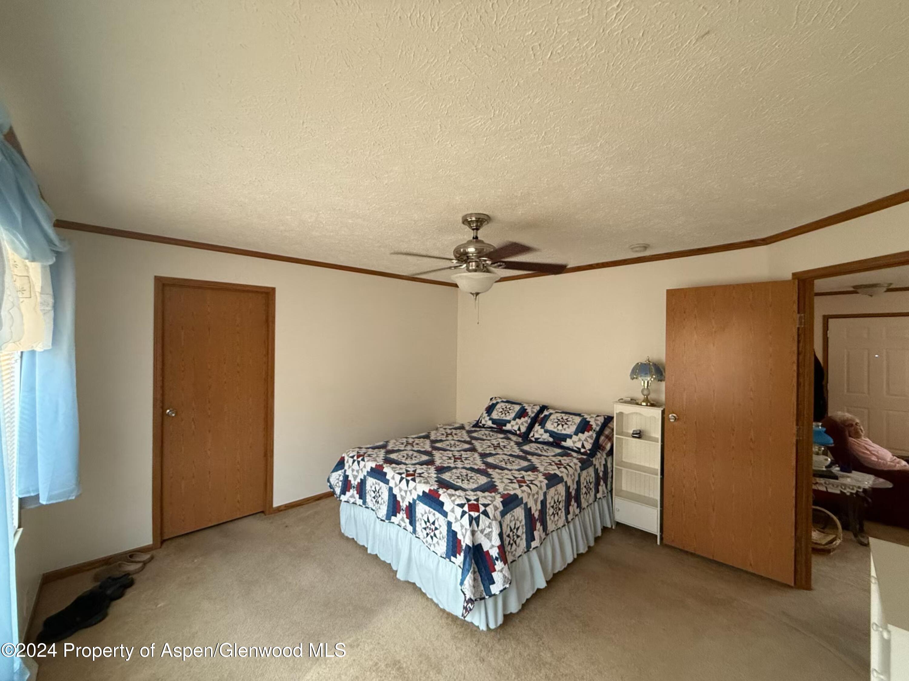 a bed sitting in a bedroom next to a window