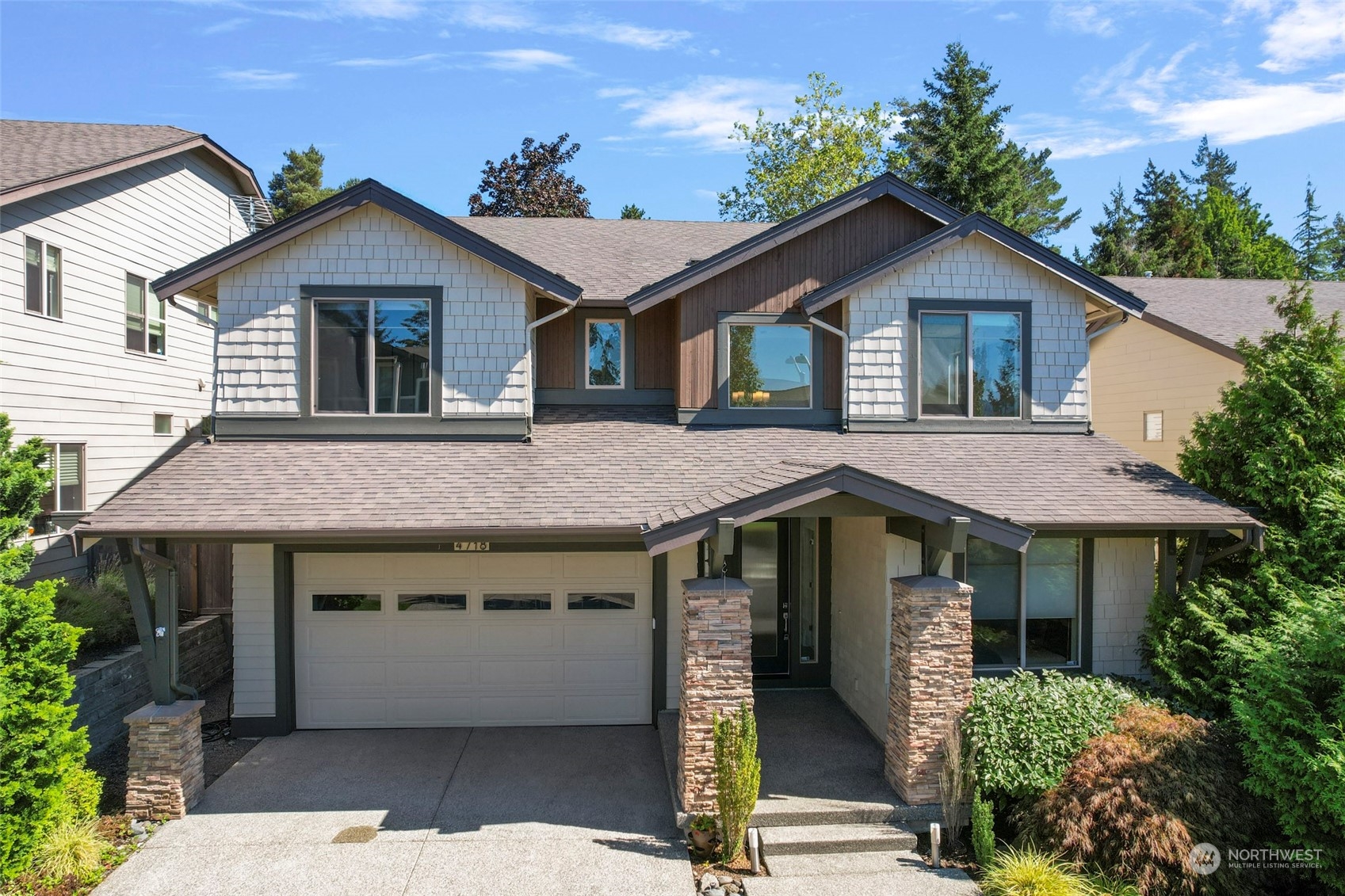 a front view of a house with garage