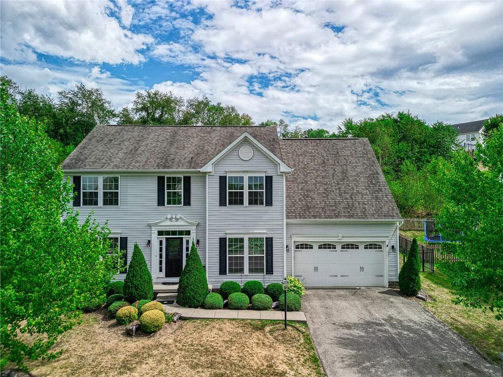 a aerial view of a house next to a yard