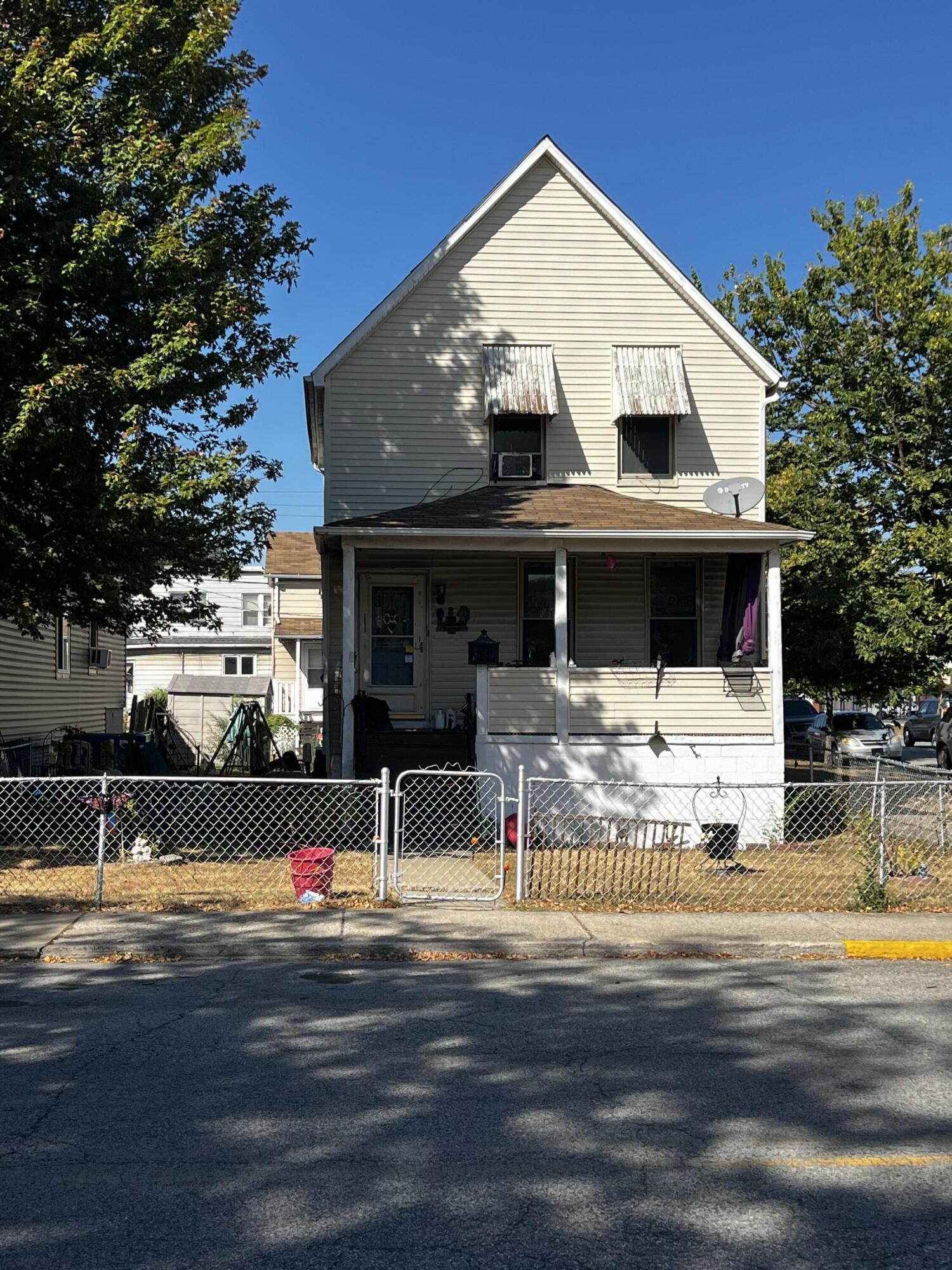 a view of house with swimming pool and a yard