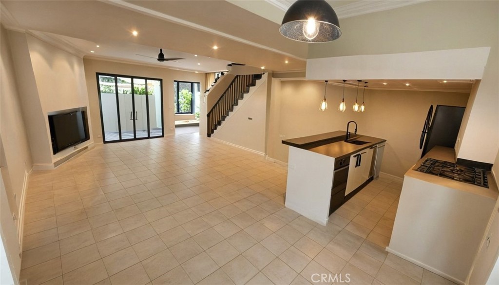 a view of a kitchen with furniture and a ceiling fan