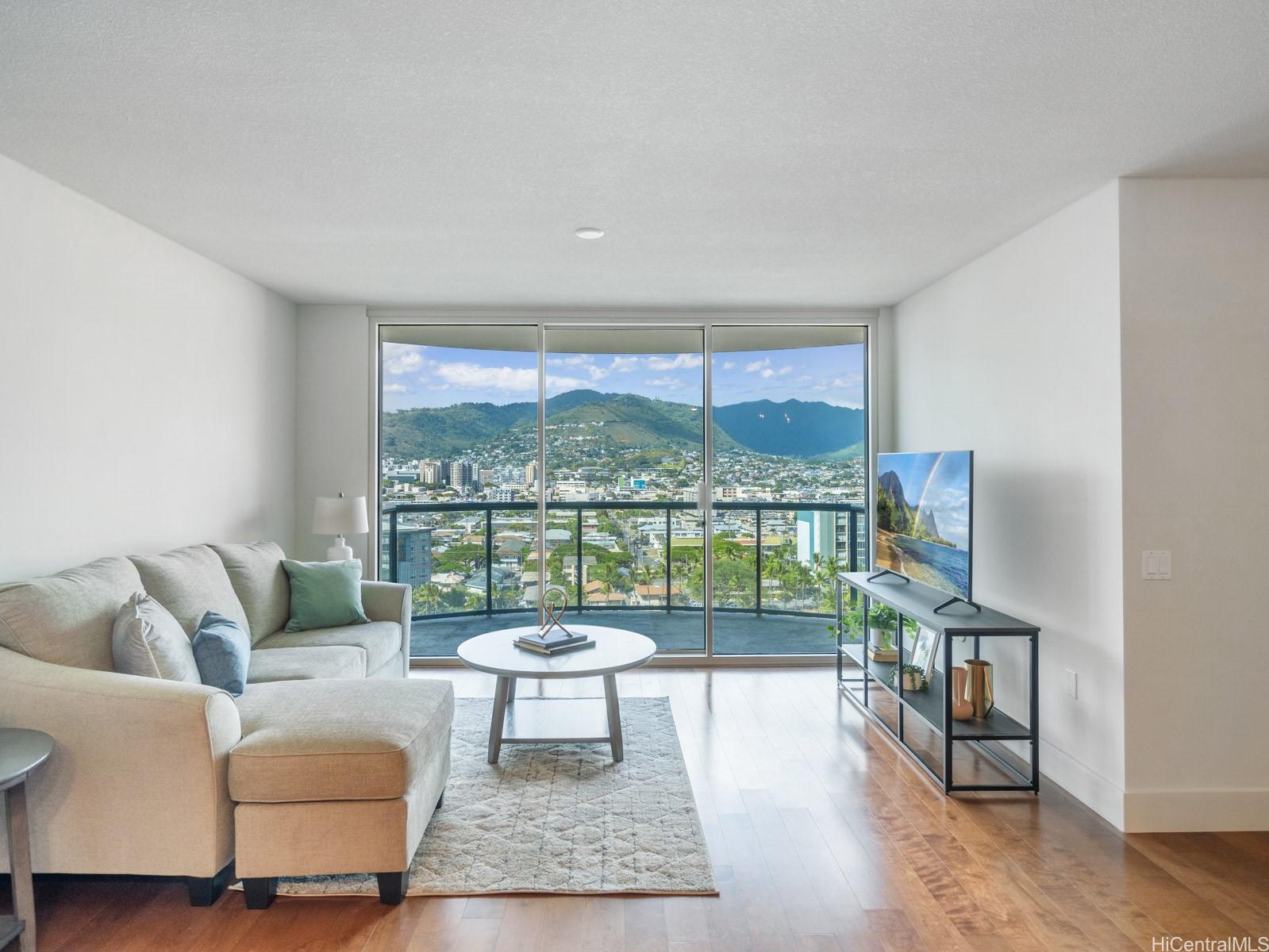 a living room with furniture and a floor to ceiling window